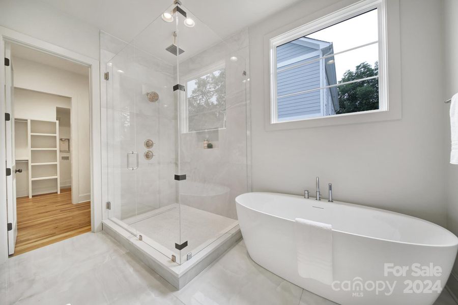 frameless glass walk-in shower with rainhead shower.