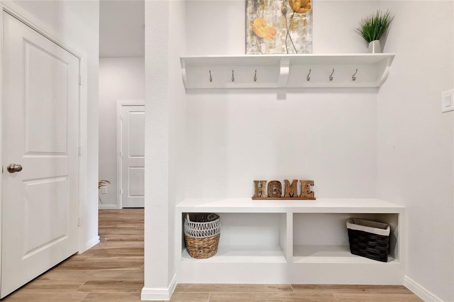 Thoughtful Design - Full view of the mudroom, walkway towards the family living room, study, and media room, showcasing the home's thoughtful layout.