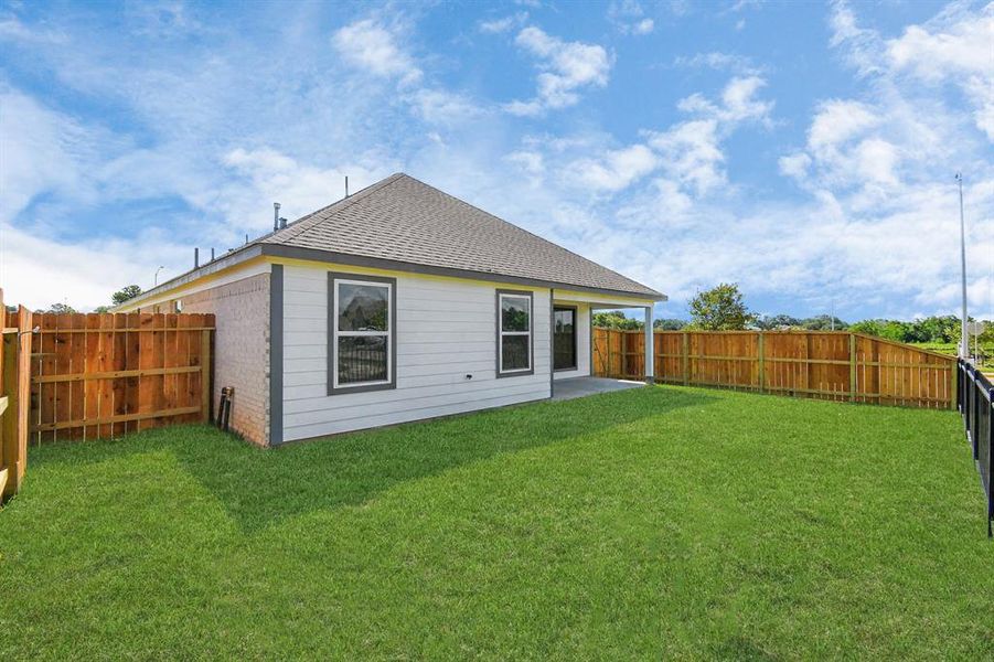 Step into a world of outdoor possibilities with this remarkable backyard and its charming covered patio. From playtime for the kids to relaxation for the adults, this space offers the best of both worlds.