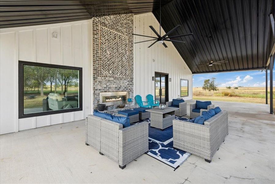 View of patio featuring an outdoor living space with a fireplace