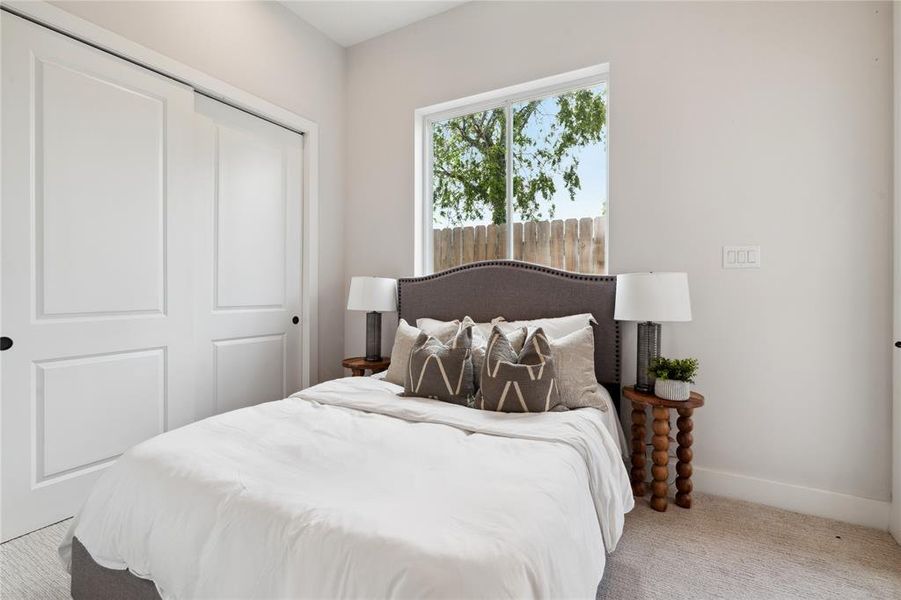 Featuring a well-designed sink and cabinet area, the connected bathroom enhances the first-floor bedroom’s functionality