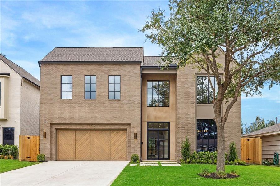 An alternate view of the front exterior highlights the clean lines and modern design, with a bright and welcoming entryway that sets the tone for the rest of the home.