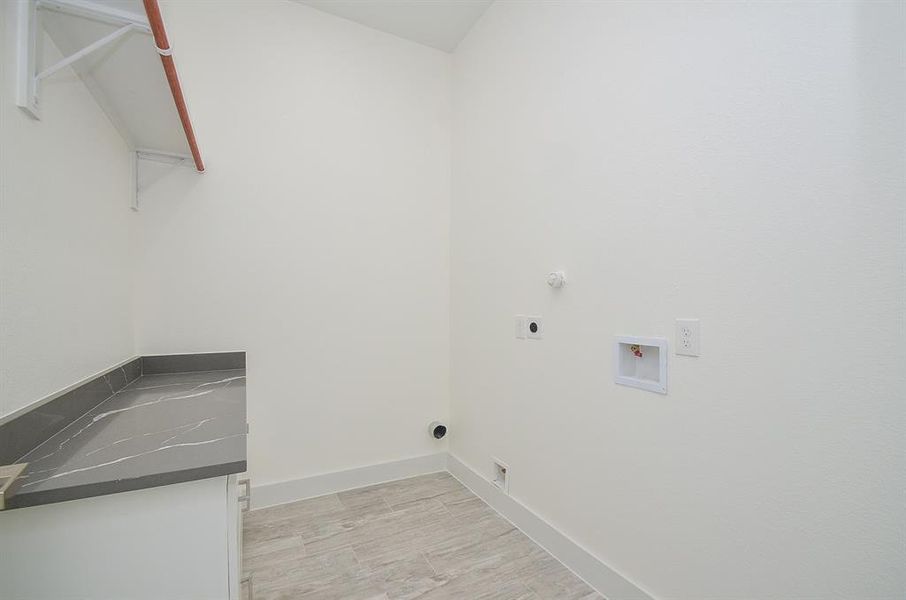 The laundry room is perfect with cabinets and drawers for extra storage and a large counter top to fold cloths.