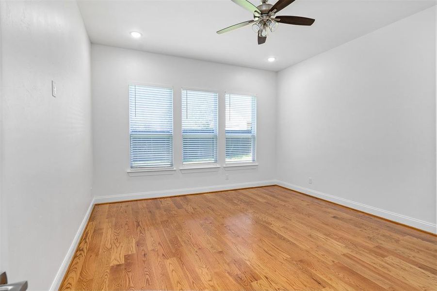 Empty room featuring ceiling fan and light hardwood / wood-style flooring