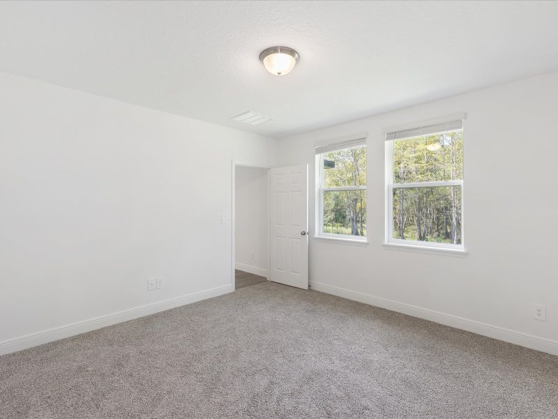 Primary bedroom in the Everglade floorplan at 232 Links Terrace Blvd