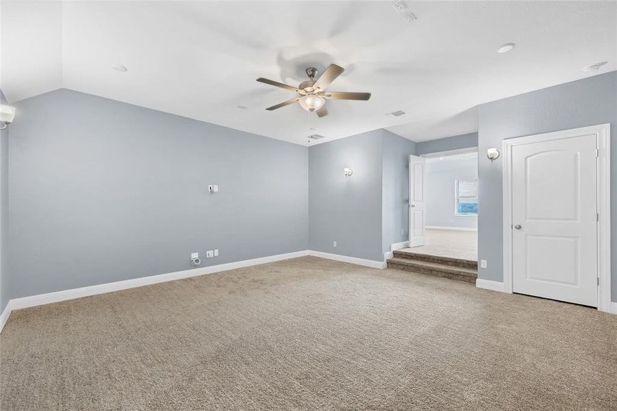 Step down into the large theater room from the second play area upstairs. Wired for surround sound and projection equipment. Four wall sconces add to theater ambiance.