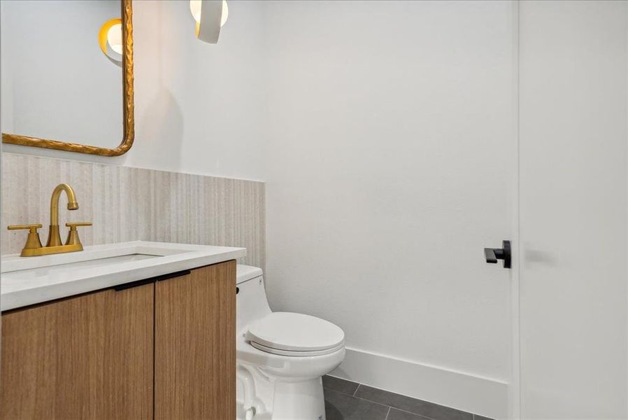 Bathroom with vanity, tile patterned flooring, and toilet