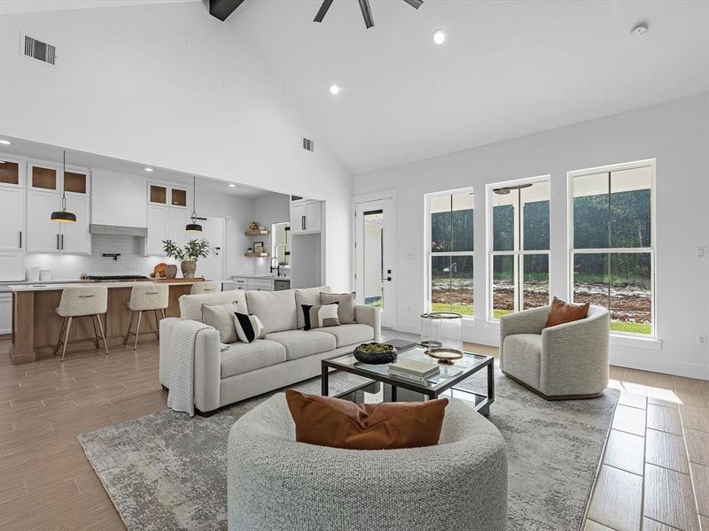 The open concept allows you to truly appreciate every inch of this home's space. The living room perfectly oversees both front and back patios, along with allowing the perfect amount of space to the kitchen island.