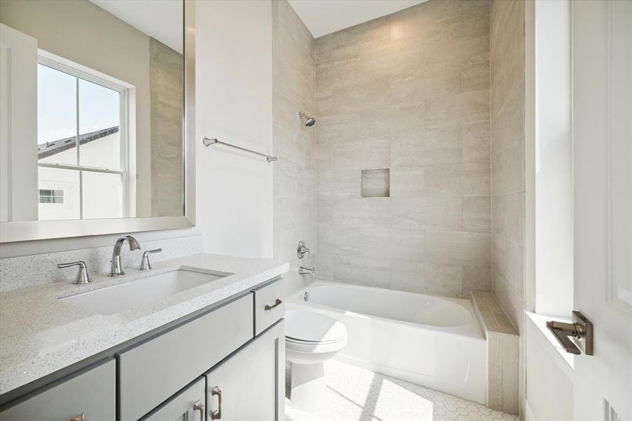 En suite bathroom with large window providing natural light.