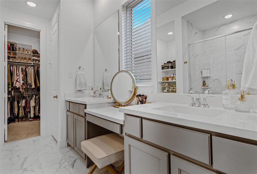 Bathroom featuring vanity and a shower with shower door