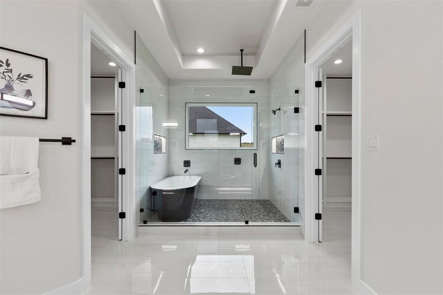 Bathroom features walk in shower with soaker tub and double closets.