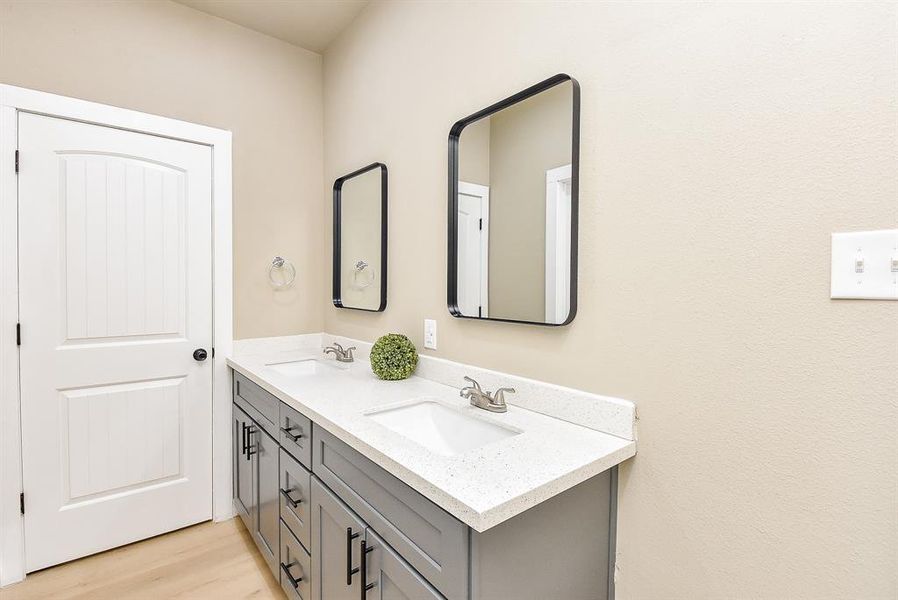 Primary En-Suite Bathroom with Double Sinks, Large Shower, and Walk-In Closet