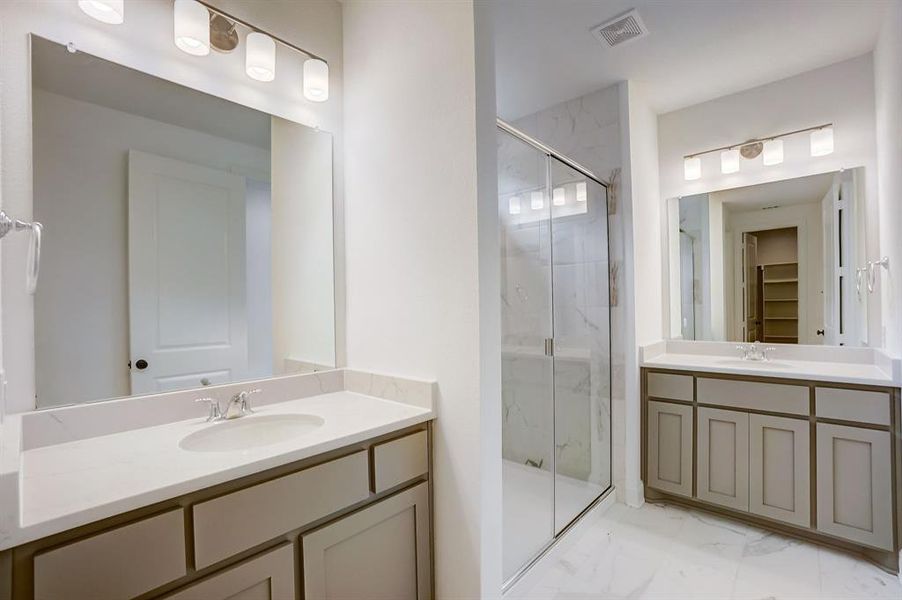 Bathroom featuring walk in shower, tile flooring, and vanity