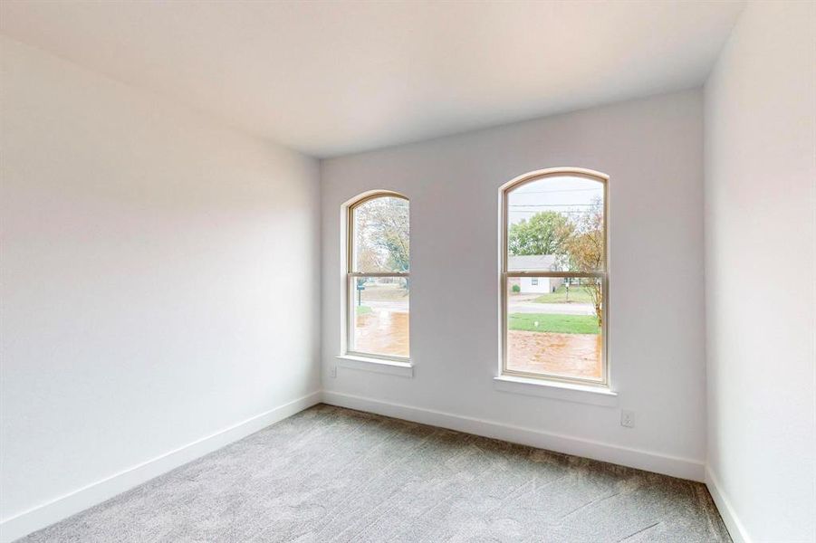 Empty room with light colored carpet