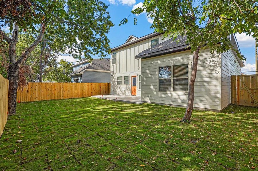 Back of property with a yard and a patio area