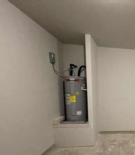 Hot water heater is in the garage for easy access