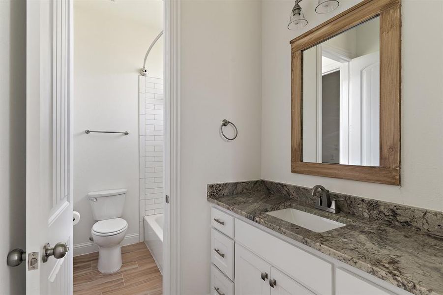 Full bathroom with shower / bath combination, toilet, and vanity