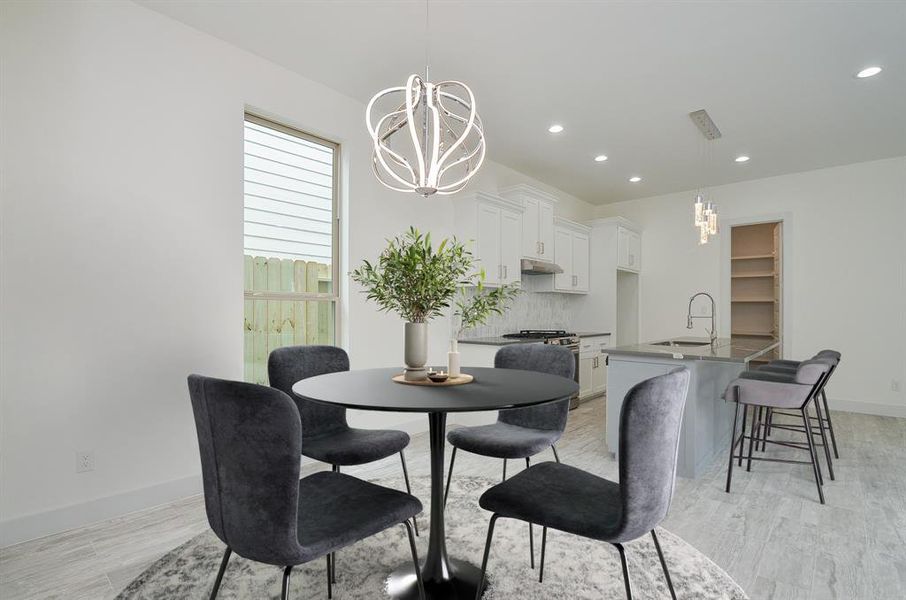 Ideal open kitchen/dining layout with gleaming and luxurious laminate floors. Plenty of space to fit whatever sized dining table you like. This large window flood the home with natural light!