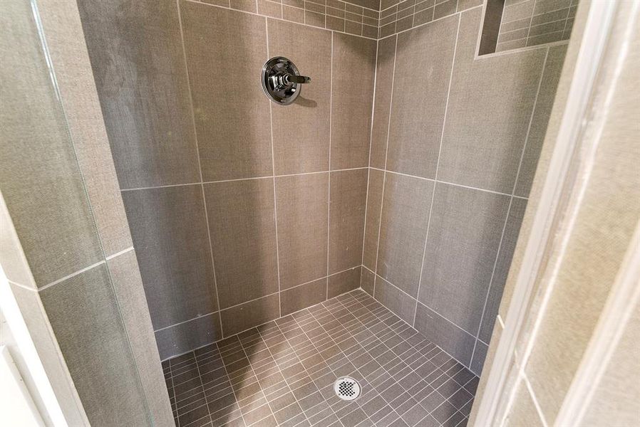 Textured tile in primary shower.