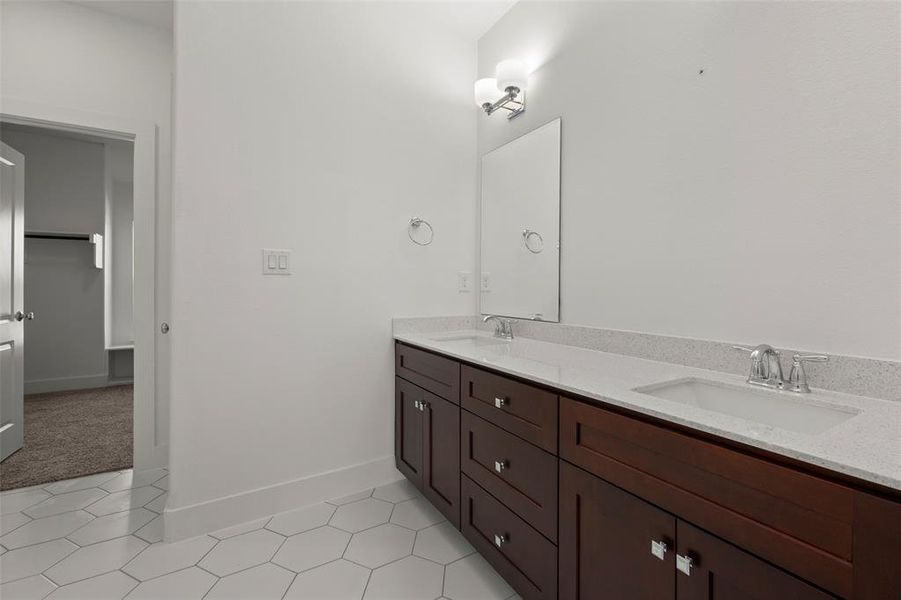 Bathroom with dual vanity and tile patterned floors