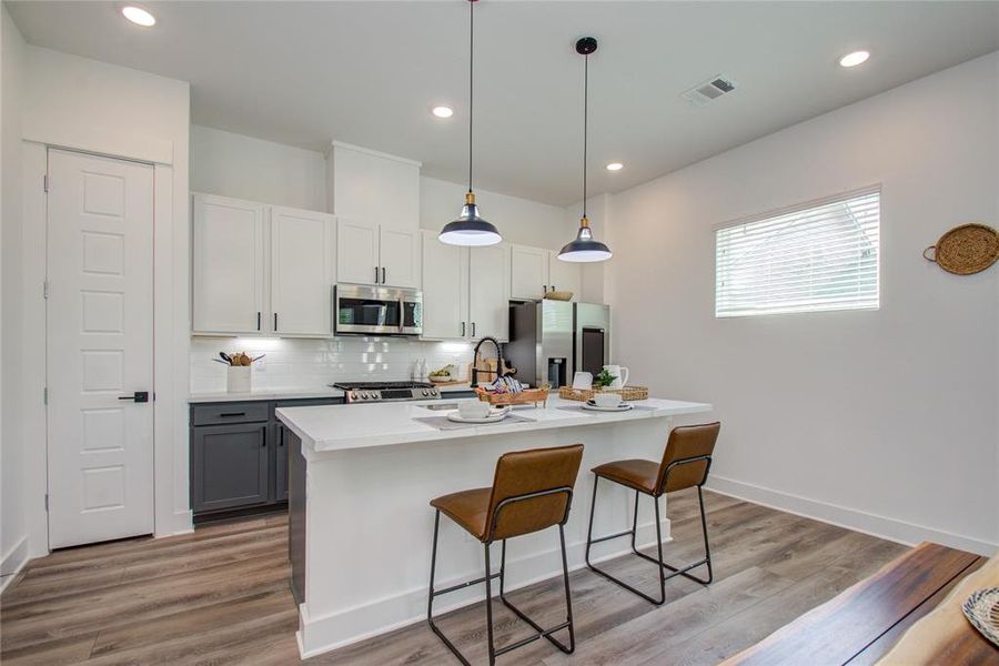 Big Kitchen Island with Quartz Counter Tops. Great for food prep and extra seating area. Model home photos - FINISHES AND LAYOUT MAY VARY! Ceiling fans are NOT INCLUDED!