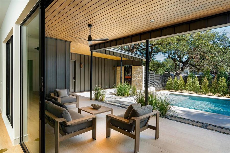 The outdoor lounge sits just outside the living room, accessible by an expansive four-part Western sliding door, making for true indoor-outdoor living.