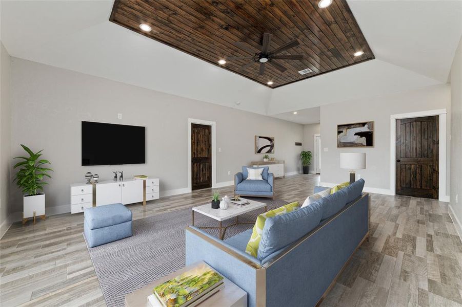 Virtually Staged. Step into the inviting open living room, where sleek tile flooring sets the foundation for comfort and style. Above, a high tray vaulted ceiling with an elegant beadboard is accented by a ceiling fan, ensuring year-round comfort and a touch of charm.