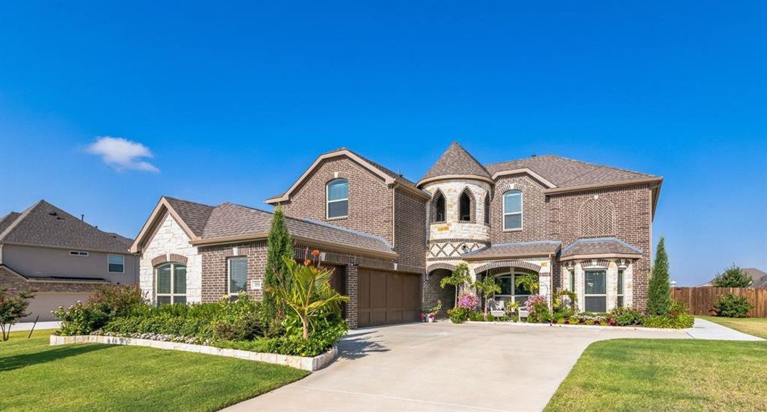 View of front of house with a garage and a front yard