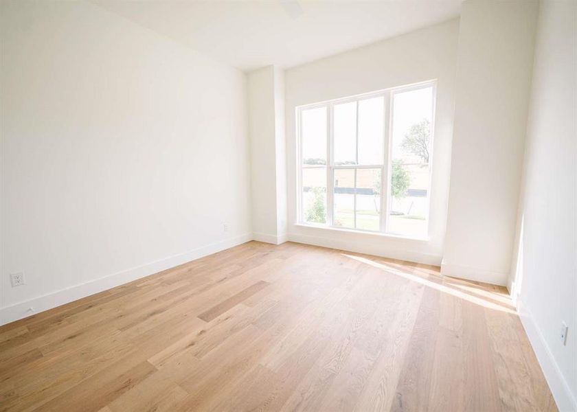 Empty room with light hardwood / wood-style floors