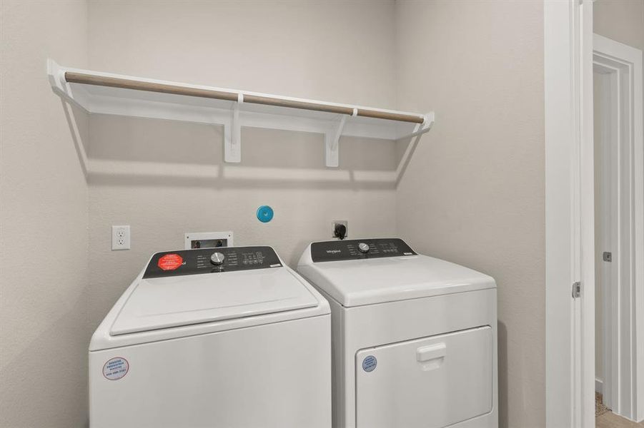 Laundry Room boasts built in shelving and hanging bar to help make laundry day a breeze!