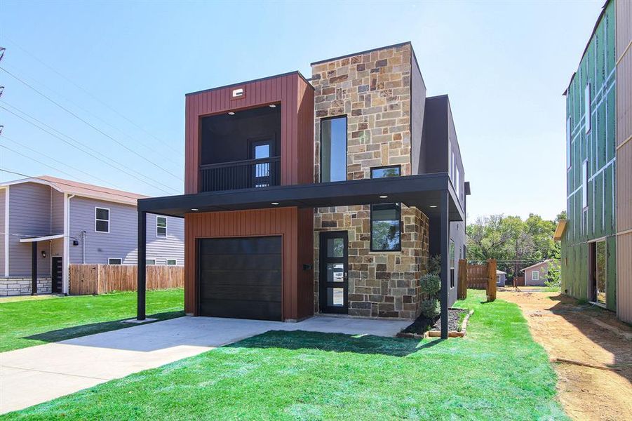 View of front facade with a front yard and a garage