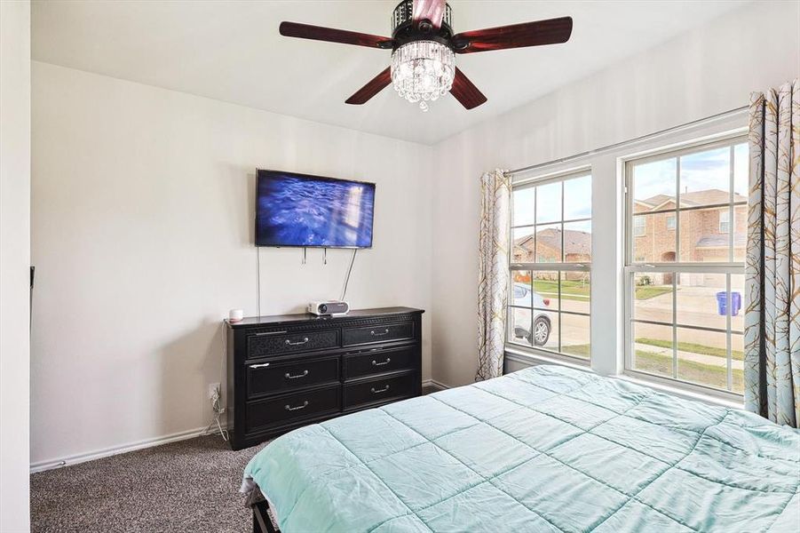 Carpeted bedroom with ceiling fan