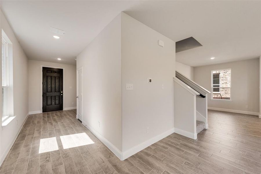 Hall with light hardwood / wood-style floors