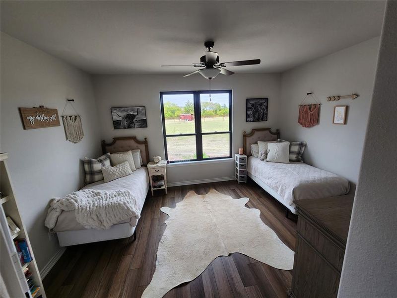 Bedroom with ceiling fan and dark hardwood / wood-style flooring