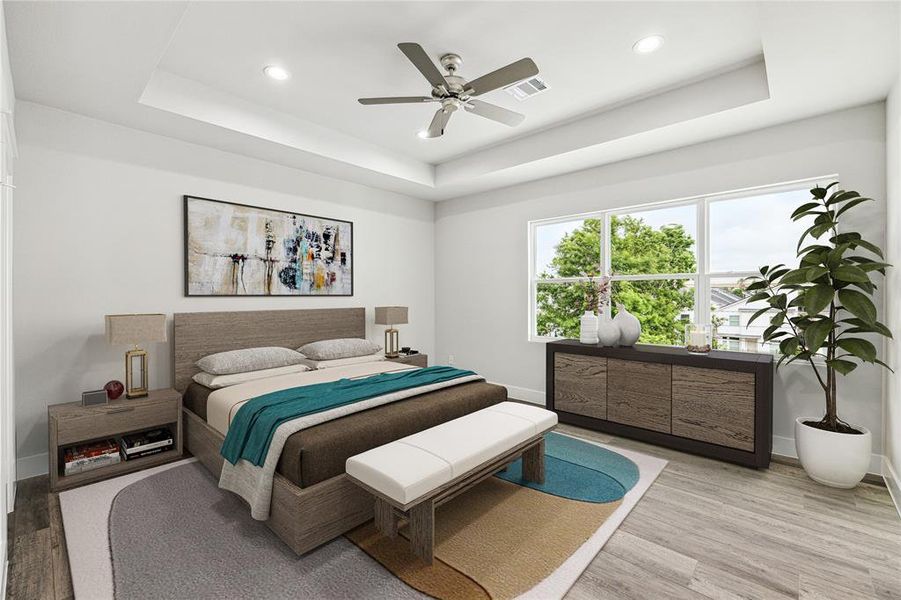 Primary Bedroom features tray ceilings and wood floors - virtually staged