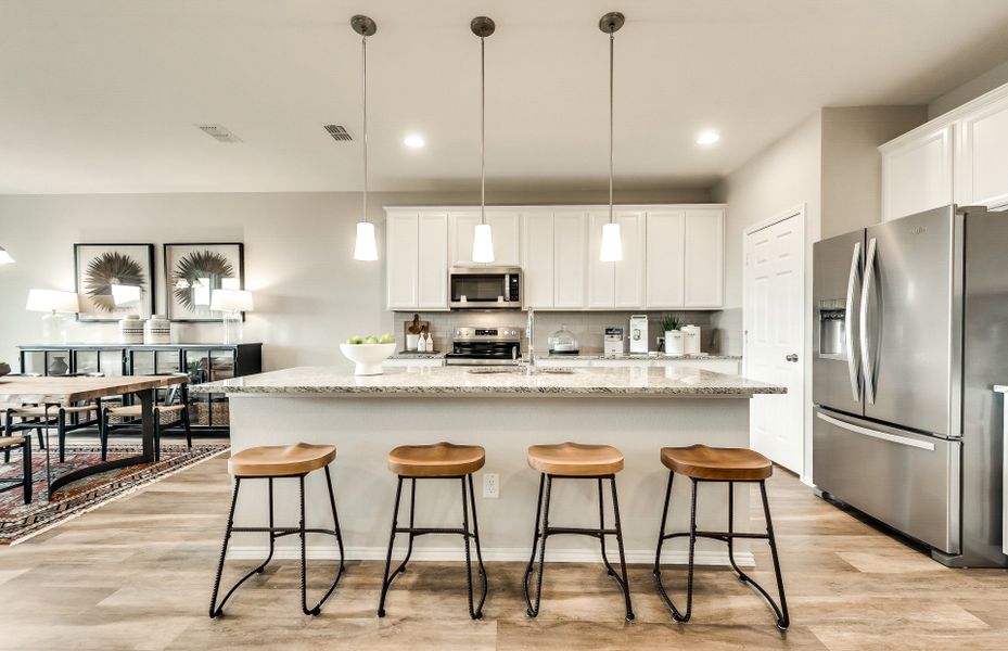 Eat-in island kitchen with recessed and pendant li