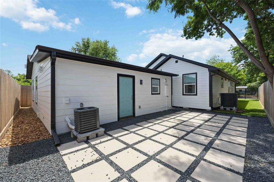 A paved backyard patio joins the main home with the adjacent guest suite.