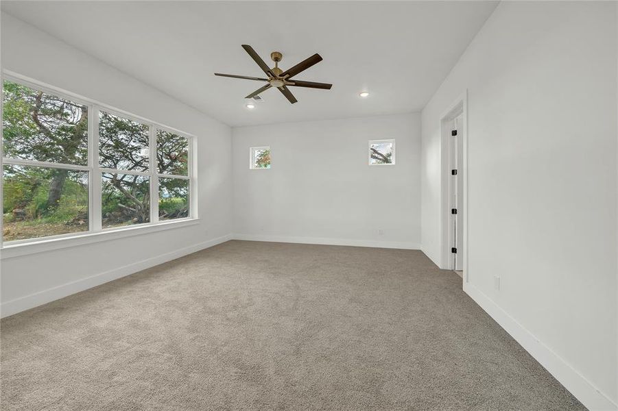 Carpeted Master bedroom with ceiling fan
