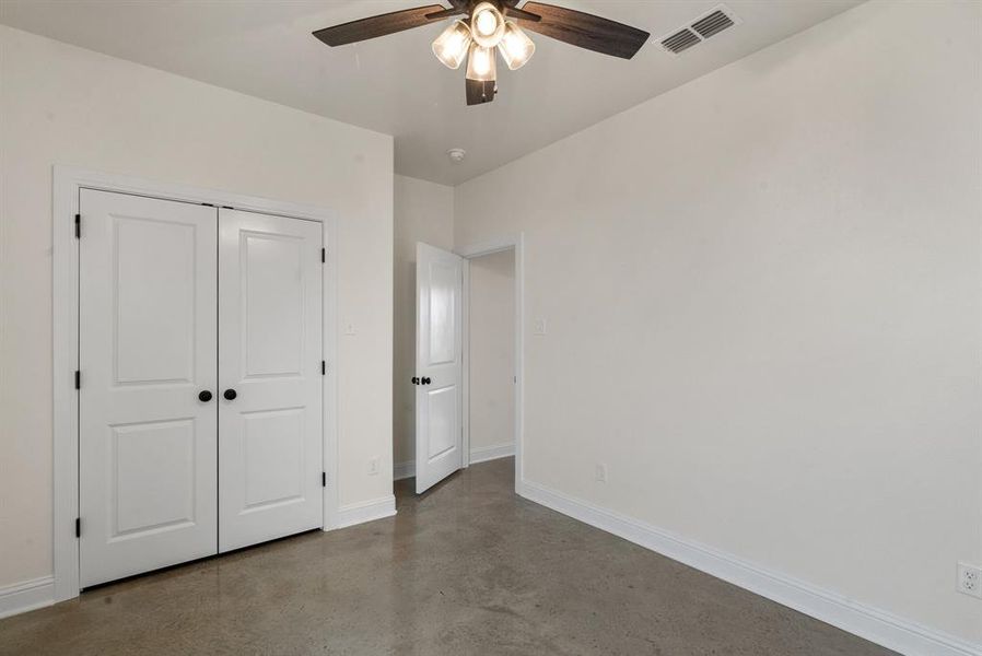 Unfurnished bedroom with a closet and ceiling fan