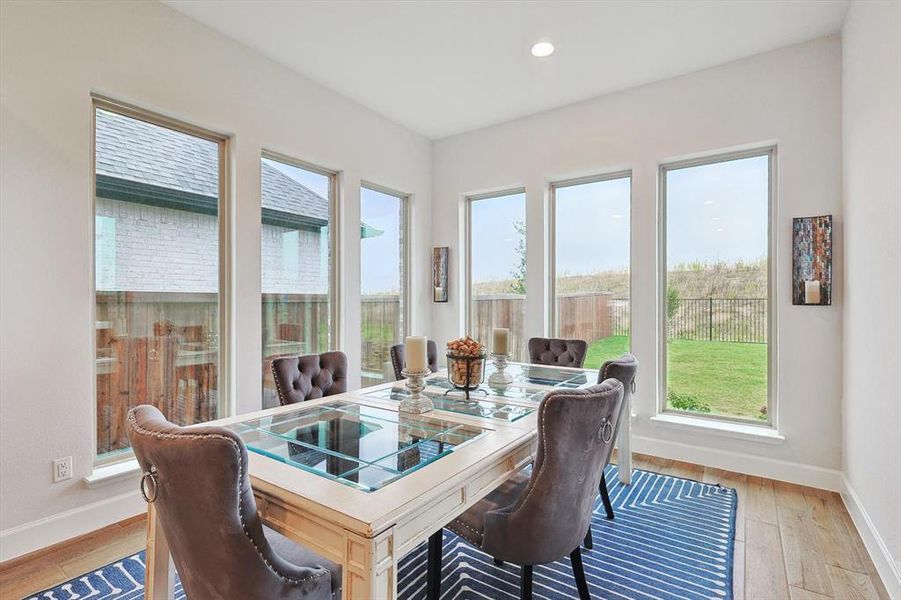 Dining room with light hardwood / wood-style flooring