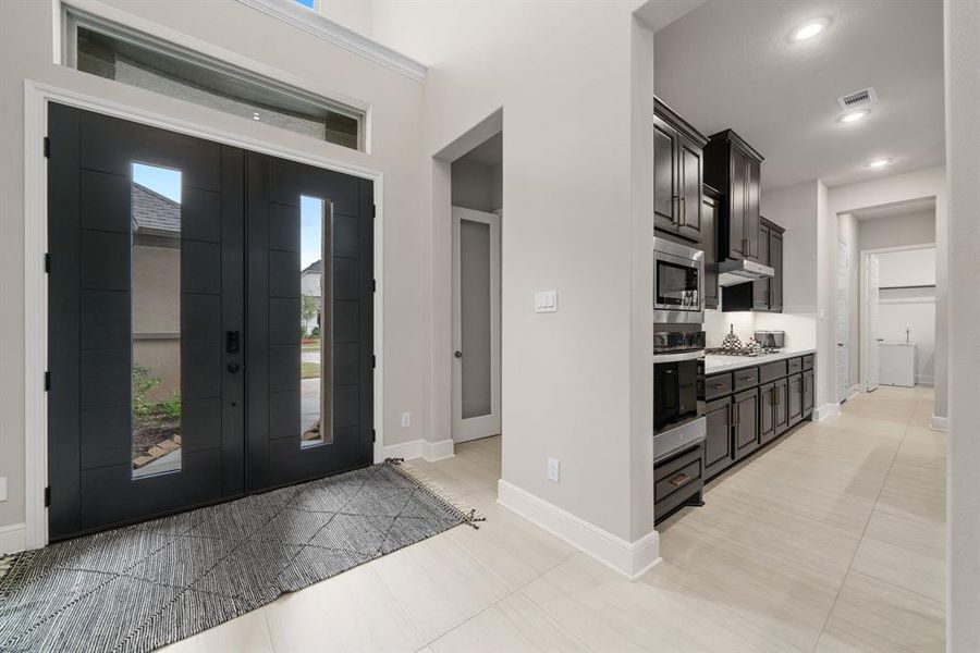 Double doors leading to high ceiling entry