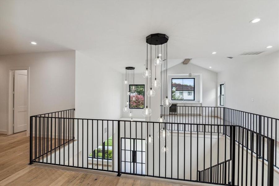 Upstairs view toward two story foyer and game room / den.