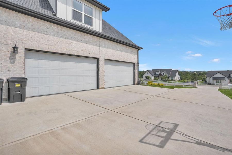 The 4-car garage has epoxied floors, and extra storage space. On the driveway, with the basketball goal, a game could break out! Plenty of space for practice and fun!