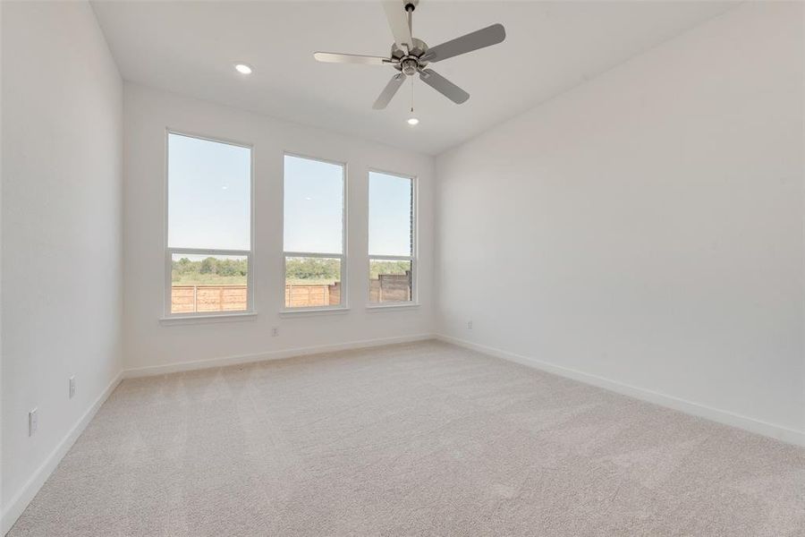 Unfurnished room with light carpet and ceiling fan