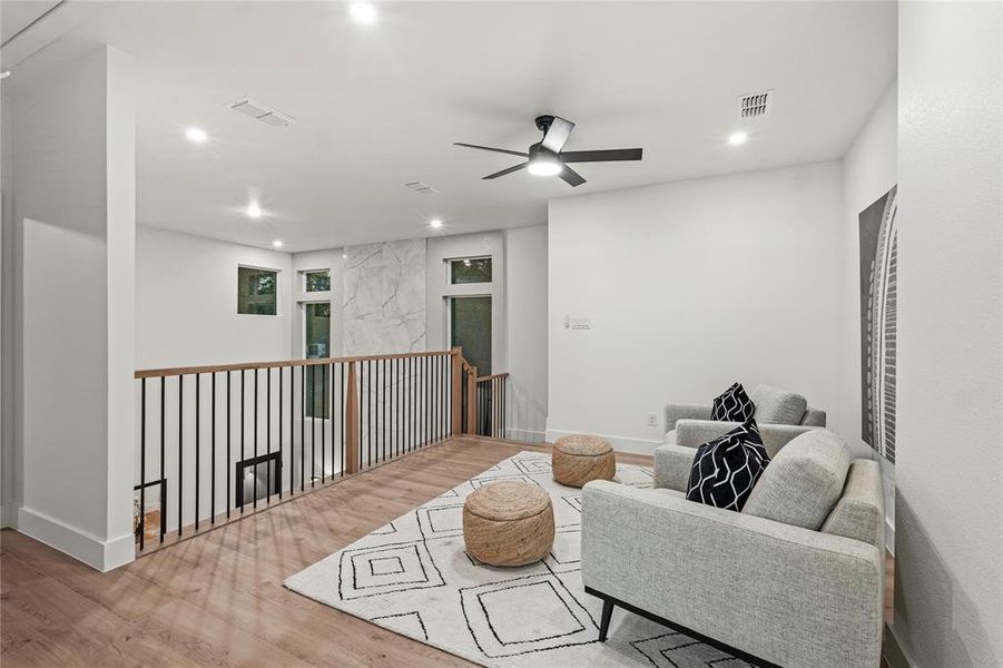 Hallway with sink and light hardwood / wood-style floors