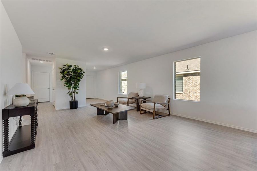 Living room with light hardwood / wood-style floors