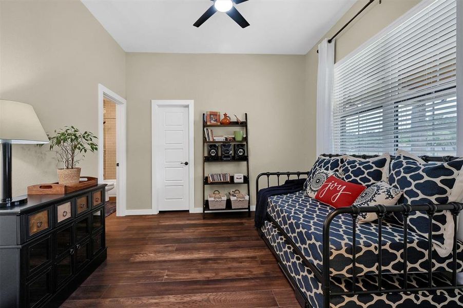 Bedroom featuring ceiling fan and dark hardwood / wood-style flooring