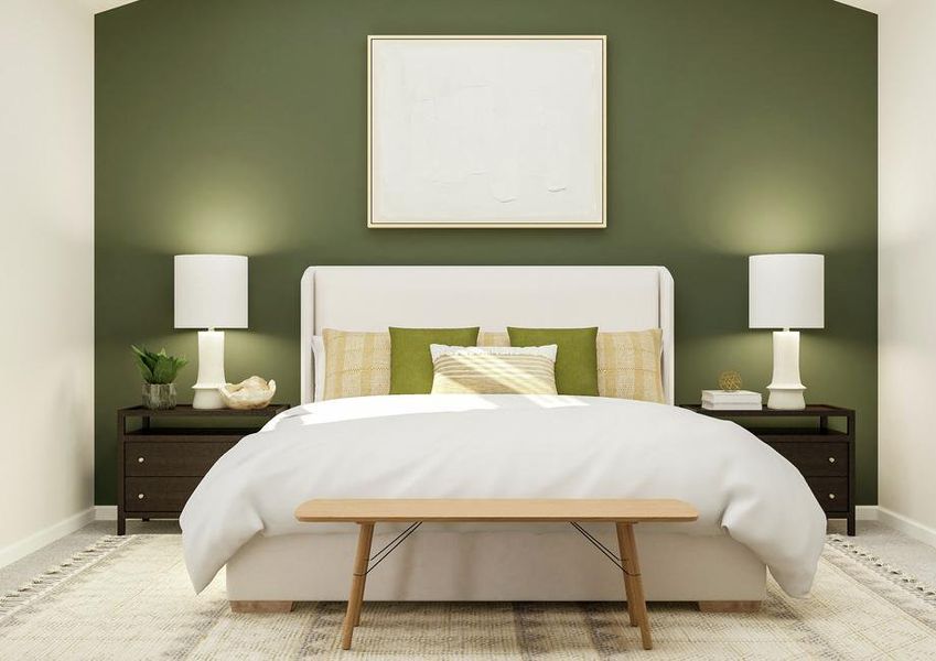Rendering of the spacious owner's suite
  featuring a large bed and two nightstands along a green accent wall with a
  view of the bathroom to the right.