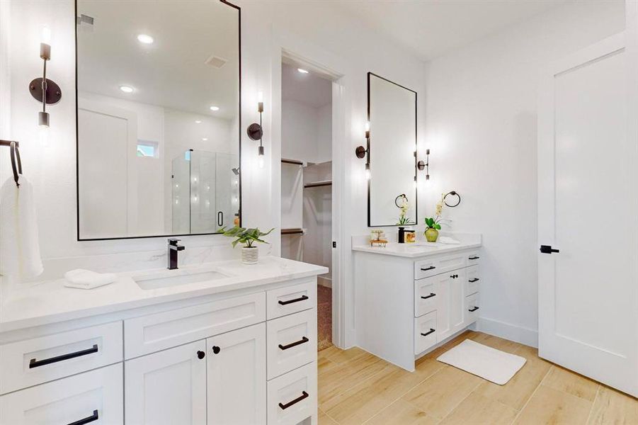 Bathroom with vanity, hardwood / wood-style flooring, and a shower with door