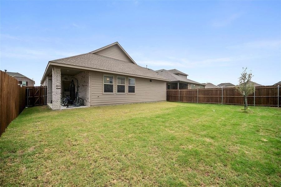 Rear view of house with a yard